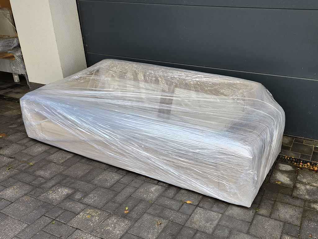 Wrapped sofa prepared for moving in Budapest